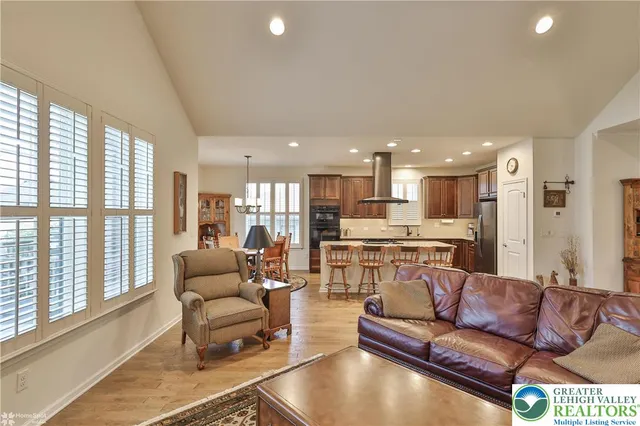 a kitchen with large cabinets a sink a window and stainless steel appliances