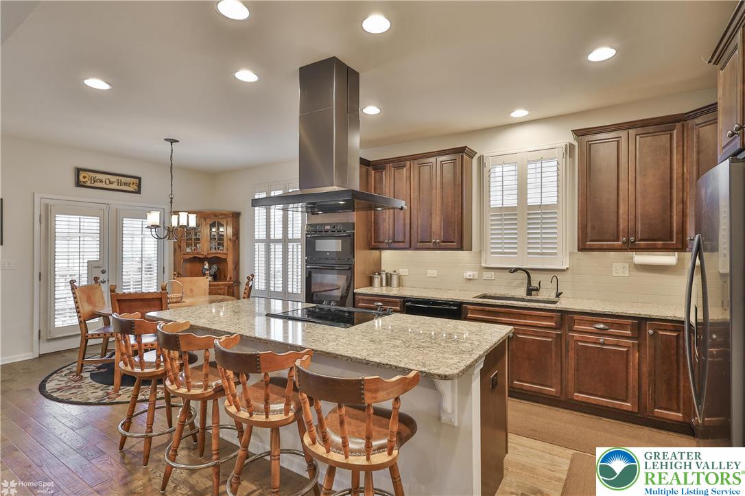 4109 Eveningstar Road Emmaus, PA 18049 - Photo 25 of 57 a kitchen with stainless steel appliances granite countertop a sink a stove and a refrigerator