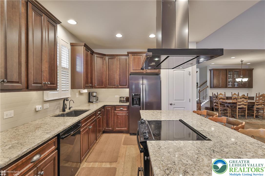 4109 Eveningstar Road Emmaus, PA 18049 - Photo 27 of 57 a kitchen with large cabinets a sink a window and stainless steel appliances