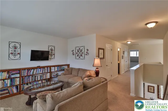 a view of house with a swimming pool and outdoor seating