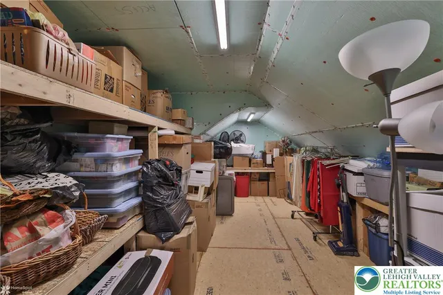 a dining room with wooden floor a chandelier a wooden table and chairs