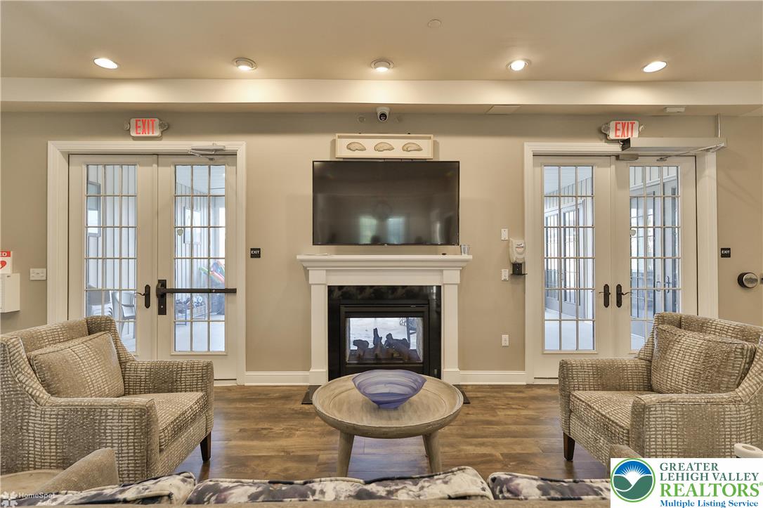 4109 Eveningstar Road Emmaus, PA 18049 - Photo 50 of 57 a living room with furniture a flat screen tv and a fireplace