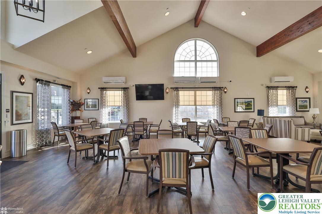 4109 Eveningstar Road Emmaus, PA 18049 - Photo 53 of 57 a dining room with wooden floor a chandelier a wooden table and chairs