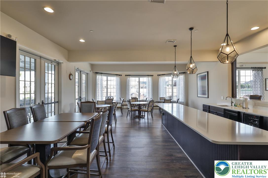 4109 Eveningstar Road Emmaus, PA 18049 - Photo 54 of 57 a view of a dining room and livingroom with lots of furniture wooden floor a chandelier