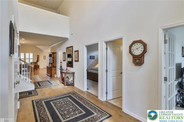 a living room with furniture a bookshelf and a large window