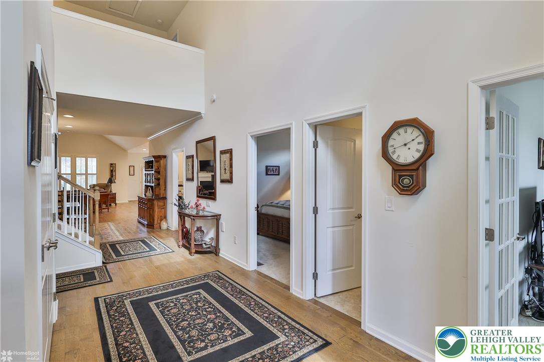 4109 Eveningstar Road Emmaus, PA 18049 - Photo 9 of 57 a view of a hallway with wooden floor and a bookshelf