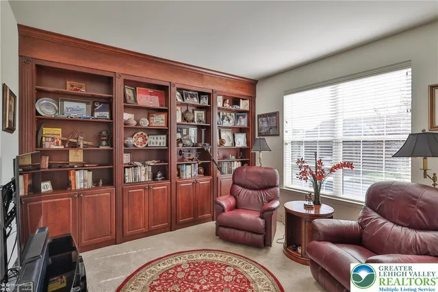 a living room with furniture a rug and a window
