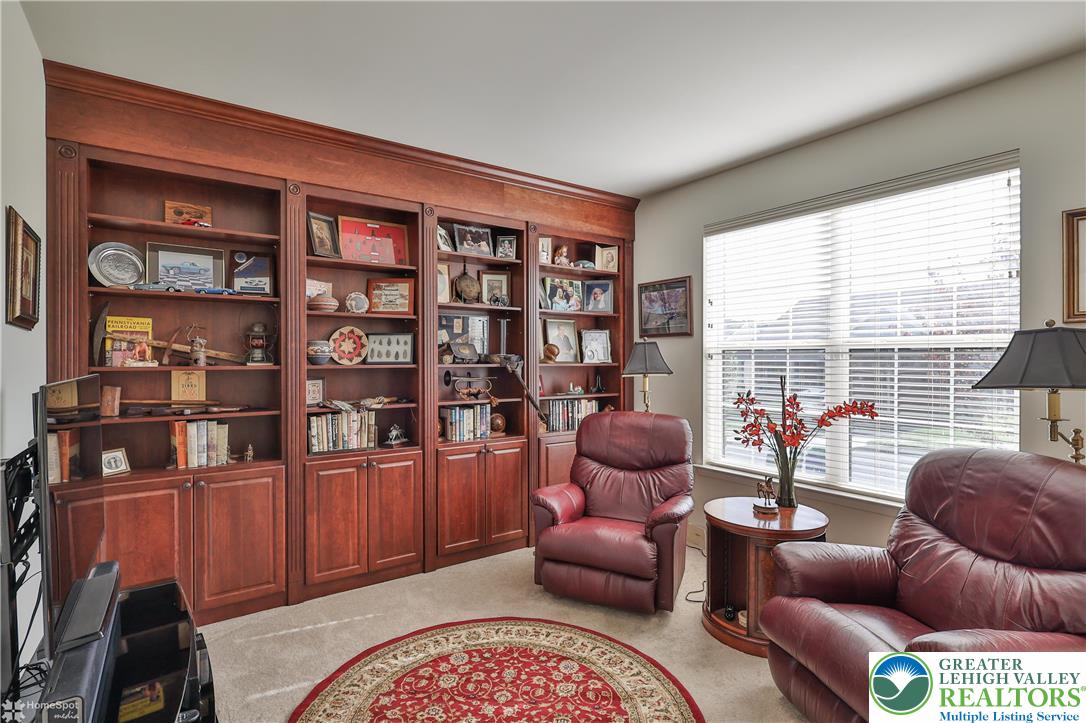 4109 Eveningstar Road Emmaus, PA 18049 - Photo 10 of 57 a living room with furniture a bookshelf and a large window