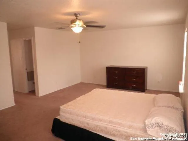 a bedroom with a bed and a dresser