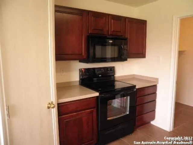 a kitchen with stainless steel appliances granite countertop a stove microwave and sink