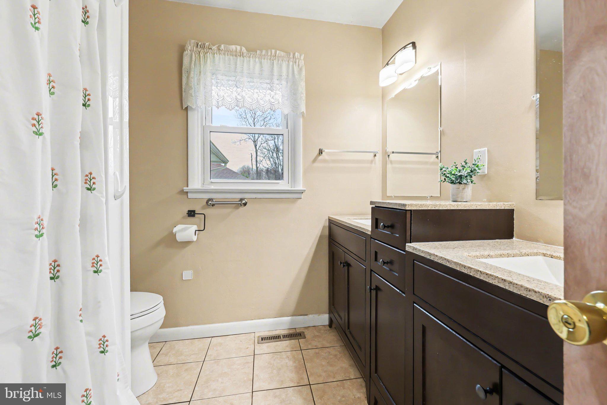 109 Adams Road Carlisle, PA 17015 - Photo 14 of 29 a bathroom with a granite countertop sink a toilet and shower
