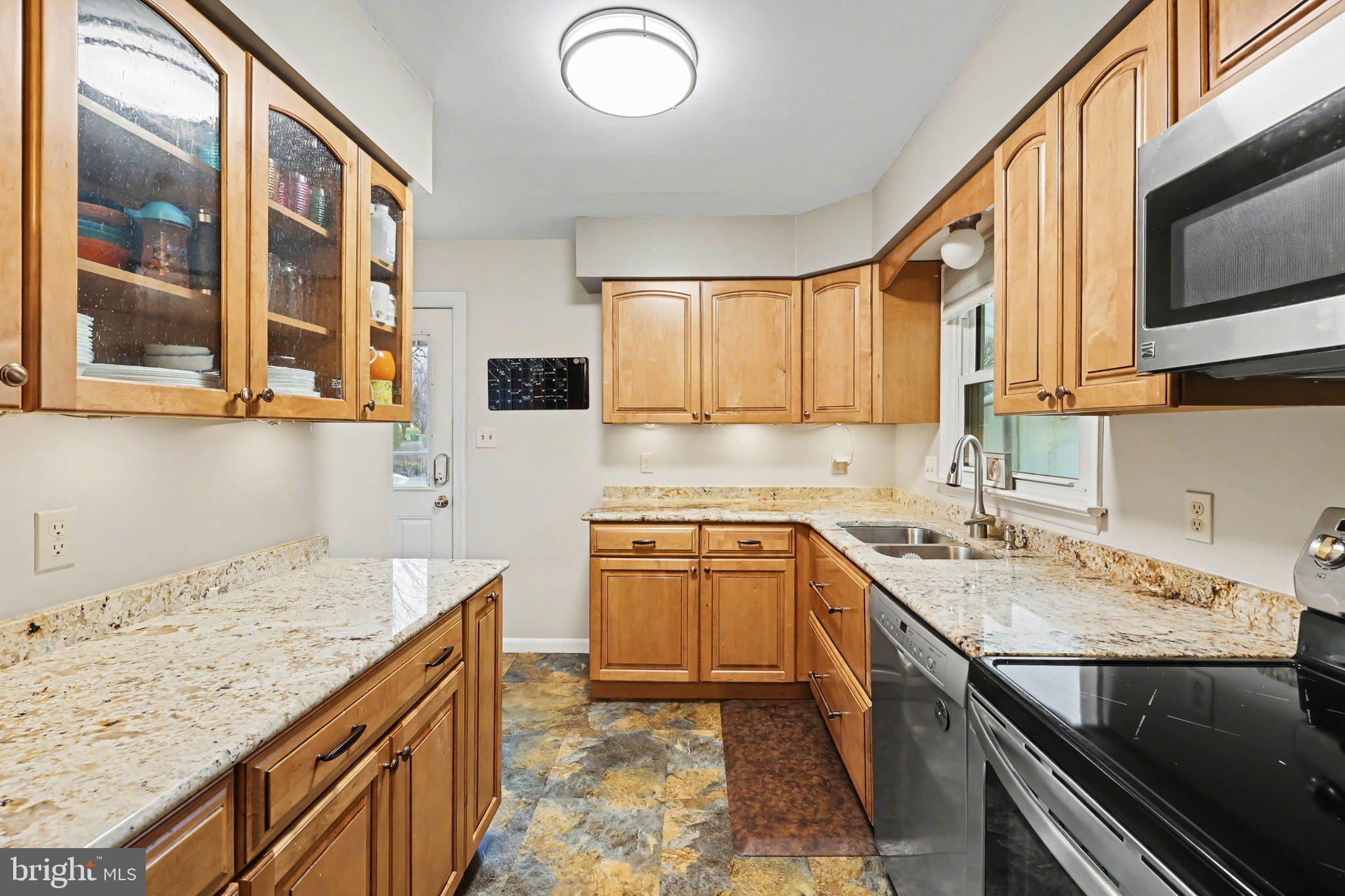 109 Adams Road Carlisle, PA 17015 - Photo 3 of 29 a kitchen with stainless steel appliances granite countertop a sink stove and microwave