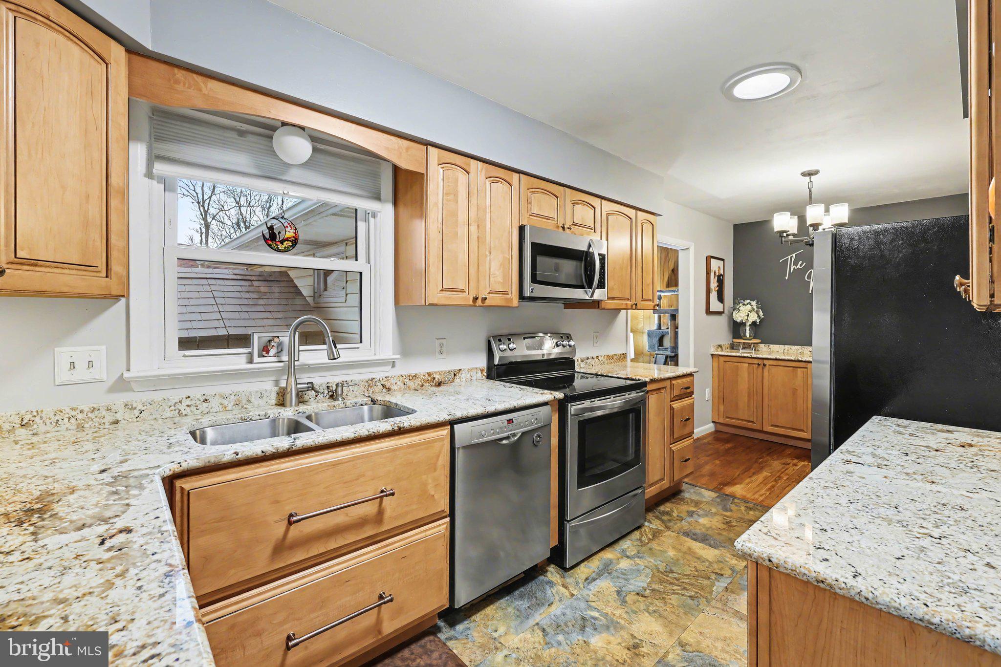 109 Adams Road Carlisle, PA 17015 - Photo 4 of 29 a kitchen with stainless steel appliances granite countertop a sink stove and refrigerator