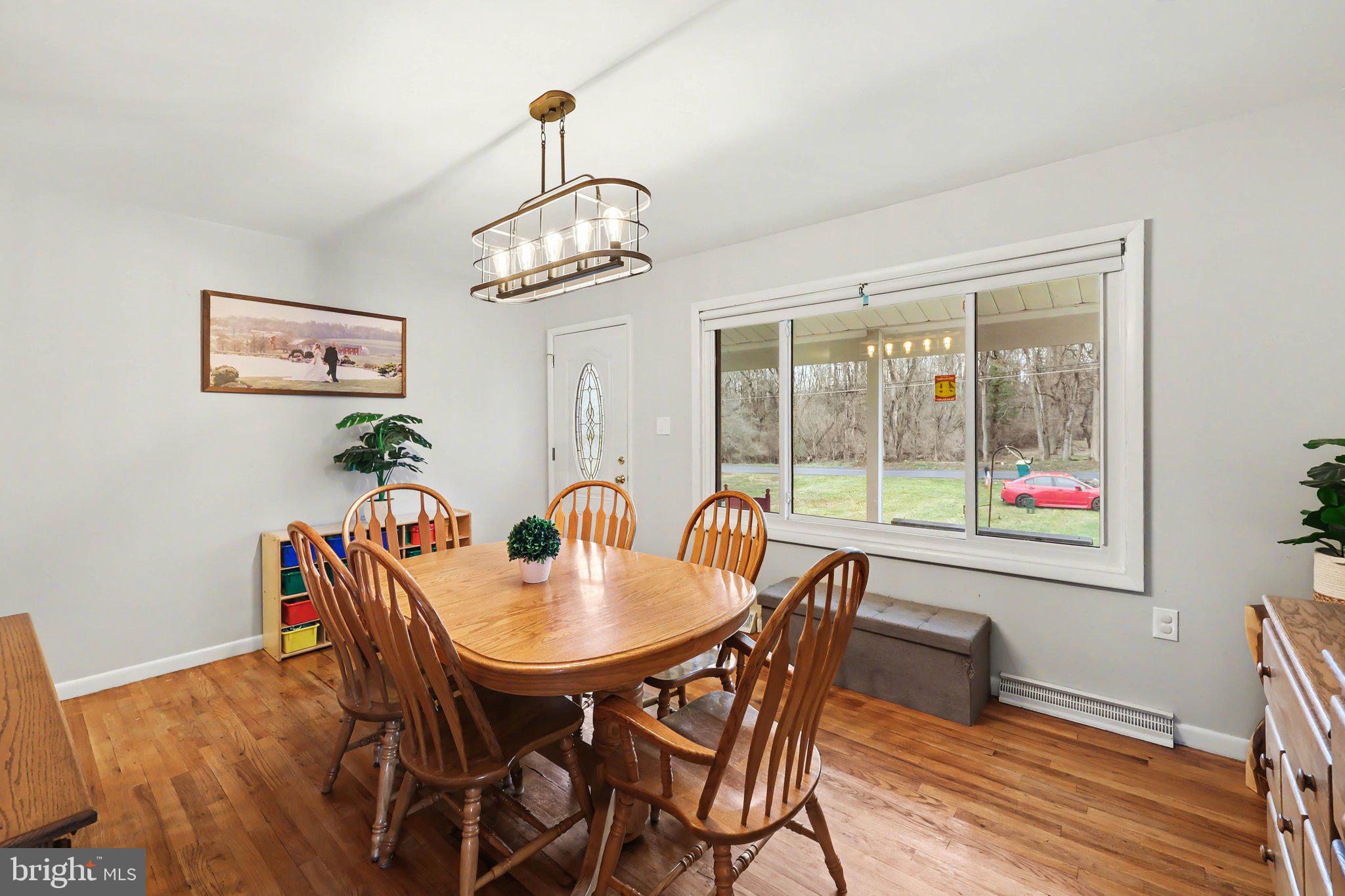 109 Adams Road Carlisle, PA 17015 - Photo 8 of 29 a view of a dining room with furniture wooden floor and a chandelier