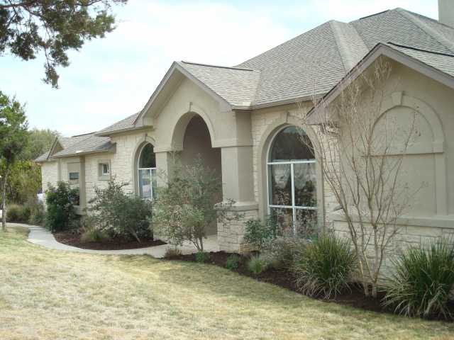 17761 West Reed Park Road Jonestown, TX 78645 - Photo 1 of 1 a front view of a house with garden