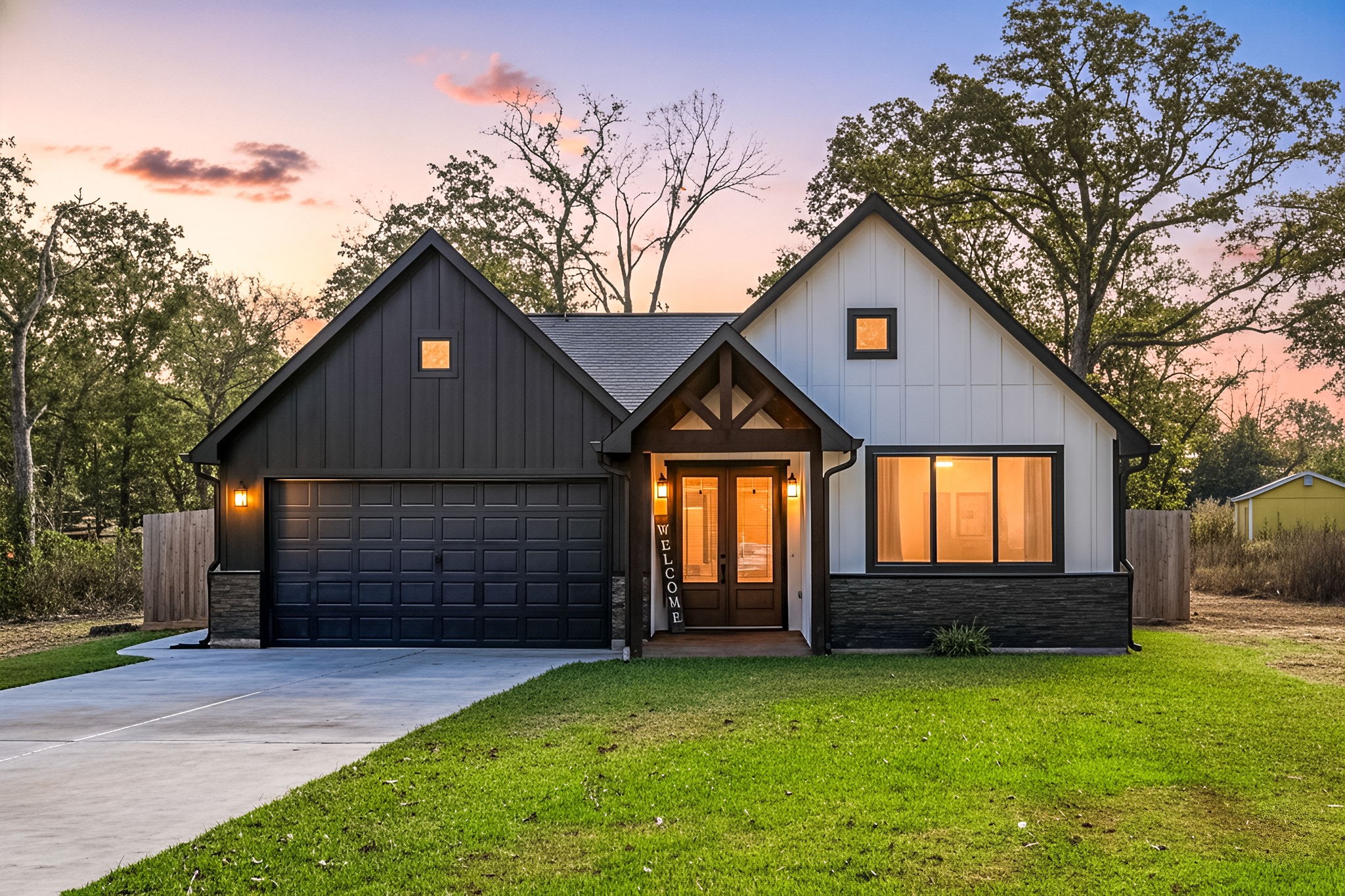 a front view of a house with a yard and garage