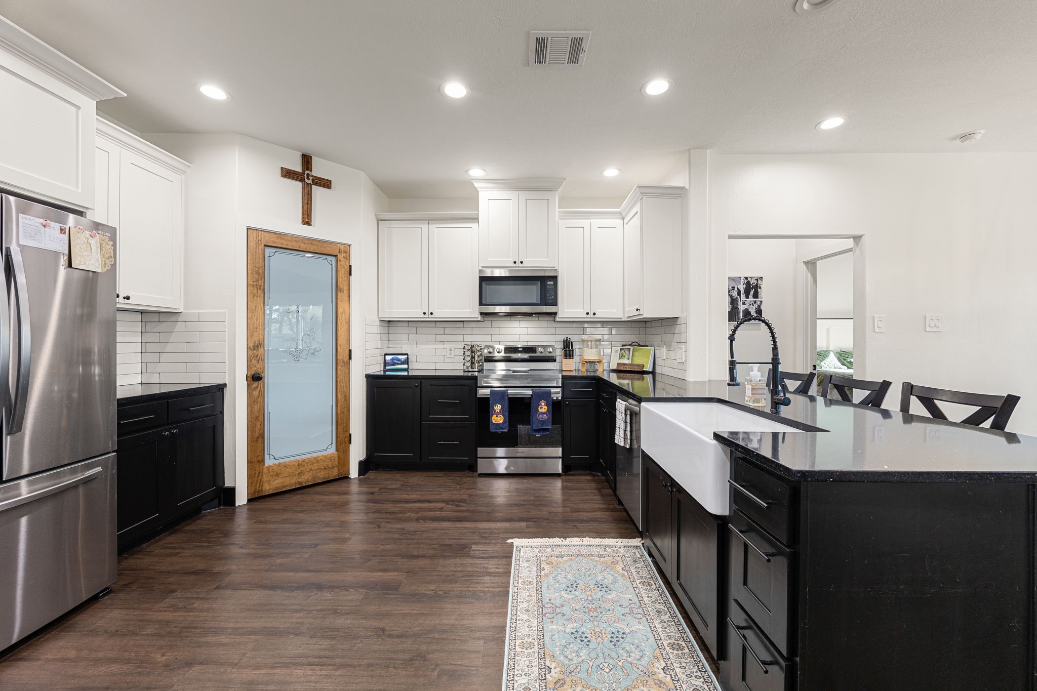 24571 Armagh Road Hempstead, TX 77445 - Photo 13 of 45 a kitchen with kitchen island granite countertop a refrigerator stove top oven and sink
