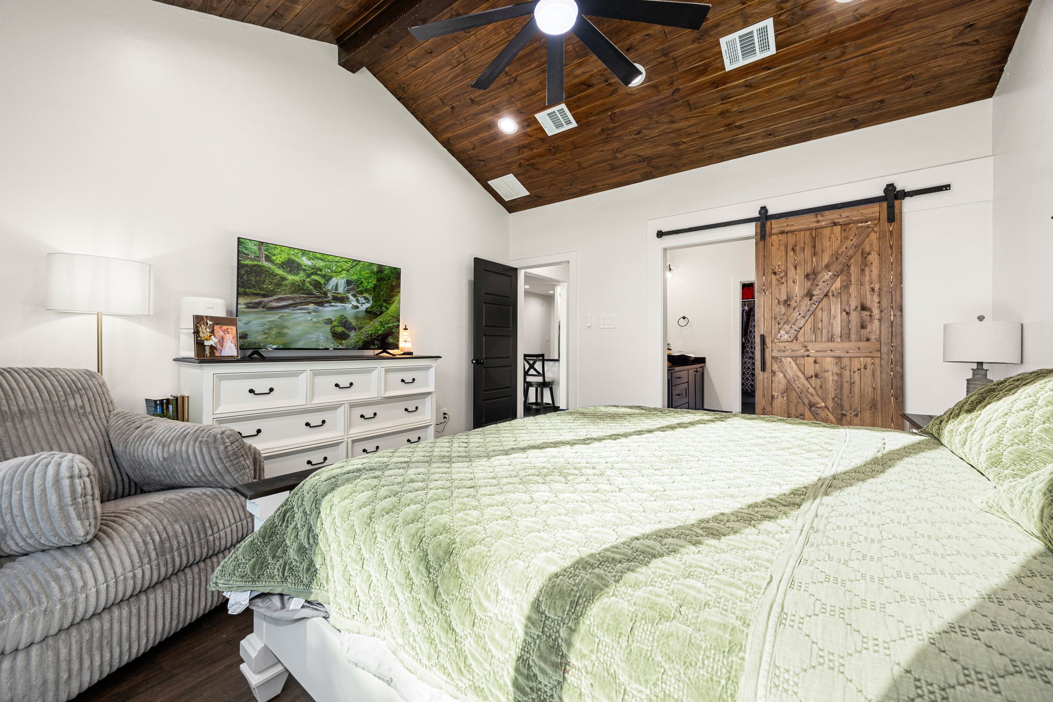 24571 Armagh Road Hempstead, TX 77445 - Photo 24 of 45 a spacious bedroom with a bed and a flat screen tv