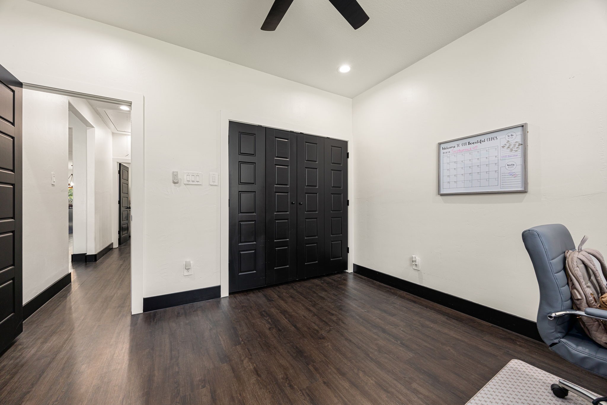24571 Armagh Road Hempstead, TX 77445 - Photo 30 of 45 a view of an empty room with wooden floor and a ceiling fan