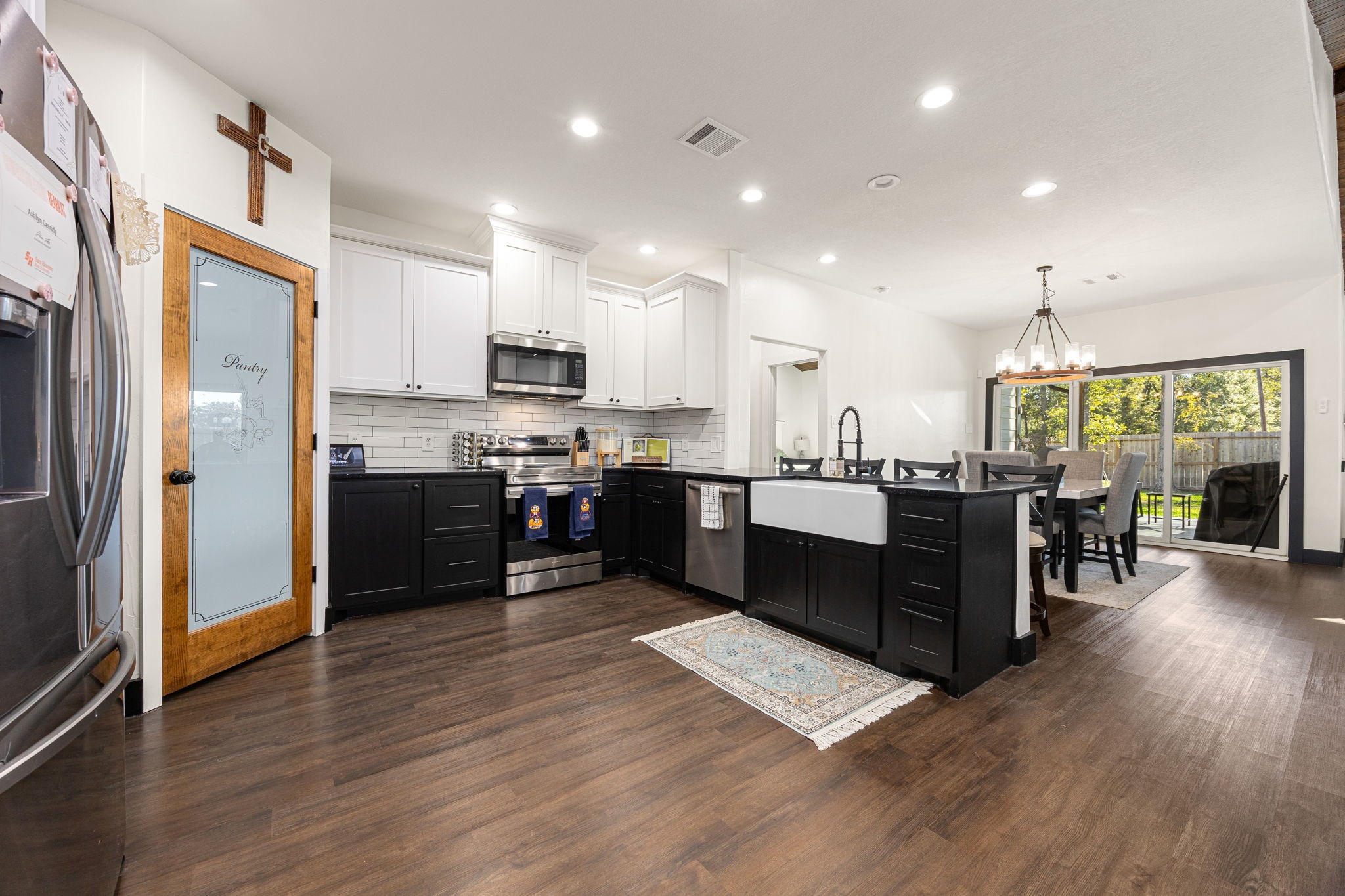 24571 Armagh Road Hempstead, TX 77445 - Photo 9 of 45 a large kitchen with stainless steel appliances kitchen island granite countertop wooden floors and a view of living room