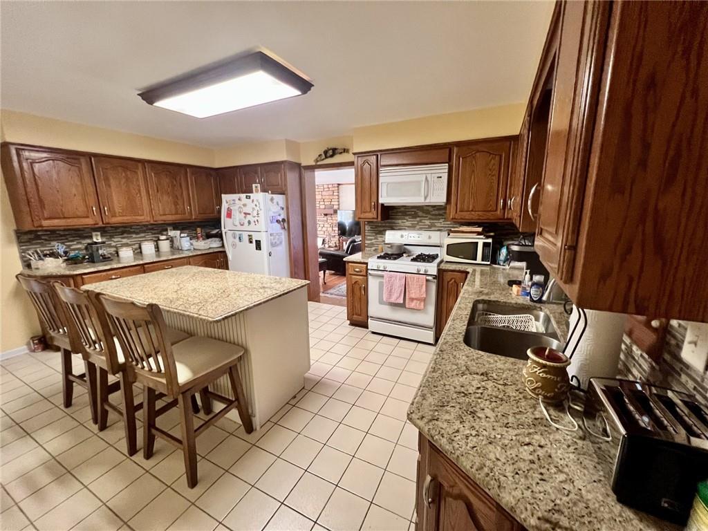 280 Derrick Avenue Uniontown, PA 15401 - Photo 13 of 28 a kitchen with stainless steel appliances granite countertop a stove top oven a sink dishwasher and cabinets