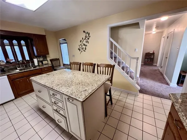 a kitchen with a stove a sink and a refrigerator