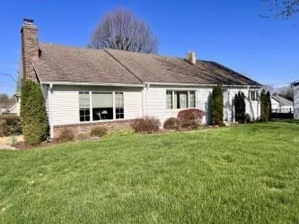 a front view of house with yard and green space