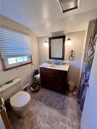 a bedroom with bed and a window