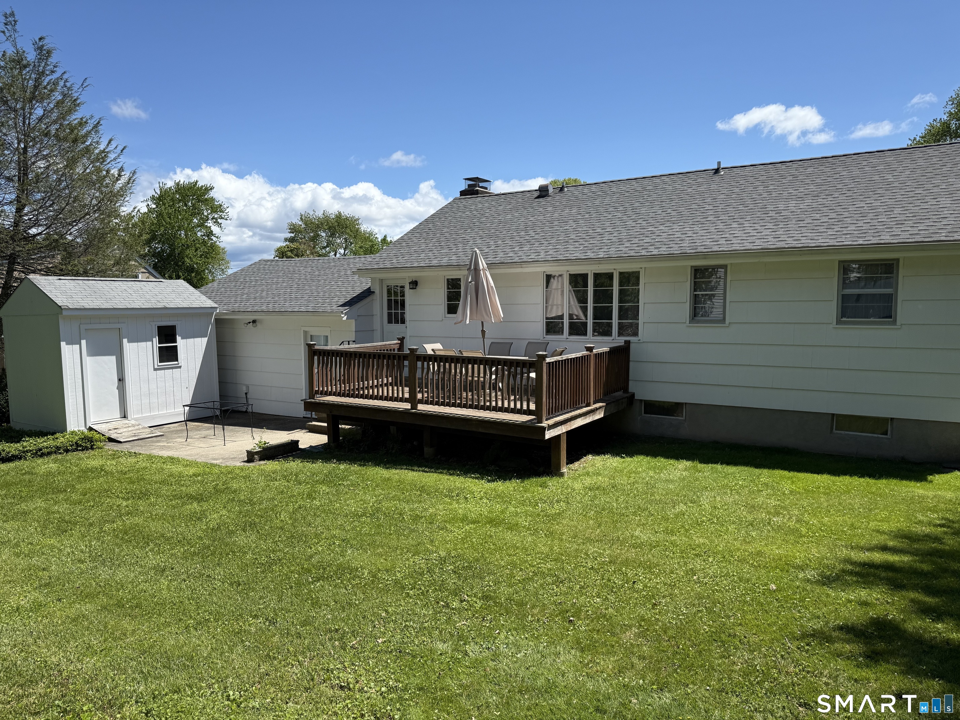 26 Maple Street Trumbull, CT 06611 - Photo 10 of 37 a view of a house with a yard and a tree