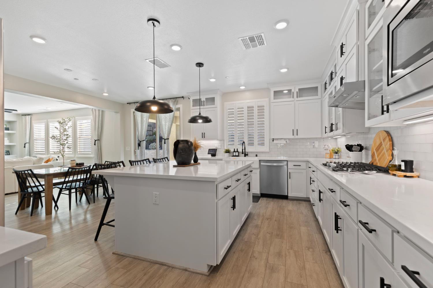 2948 Laredo Drive Rocklin, CA 95765 - Photo 21 of 54 a kitchen with appliances a sink a stove top oven a dining table and chairs