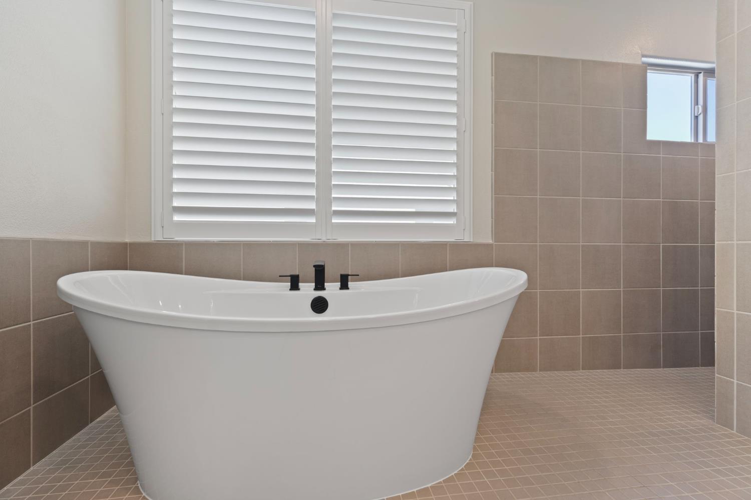 2948 Laredo Drive Rocklin, CA 95765 - Photo 33 of 54 a white bath tub sitting in a bathroom