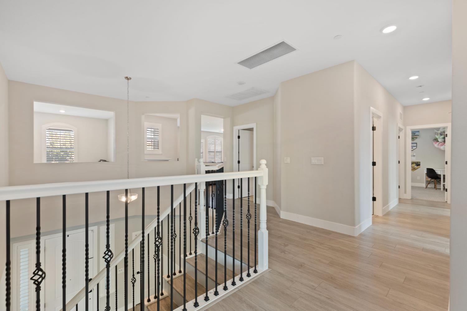 2948 Laredo Drive Rocklin, CA 95765 - Photo 34 of 54 a view of a hallway with wooden floor and windows
