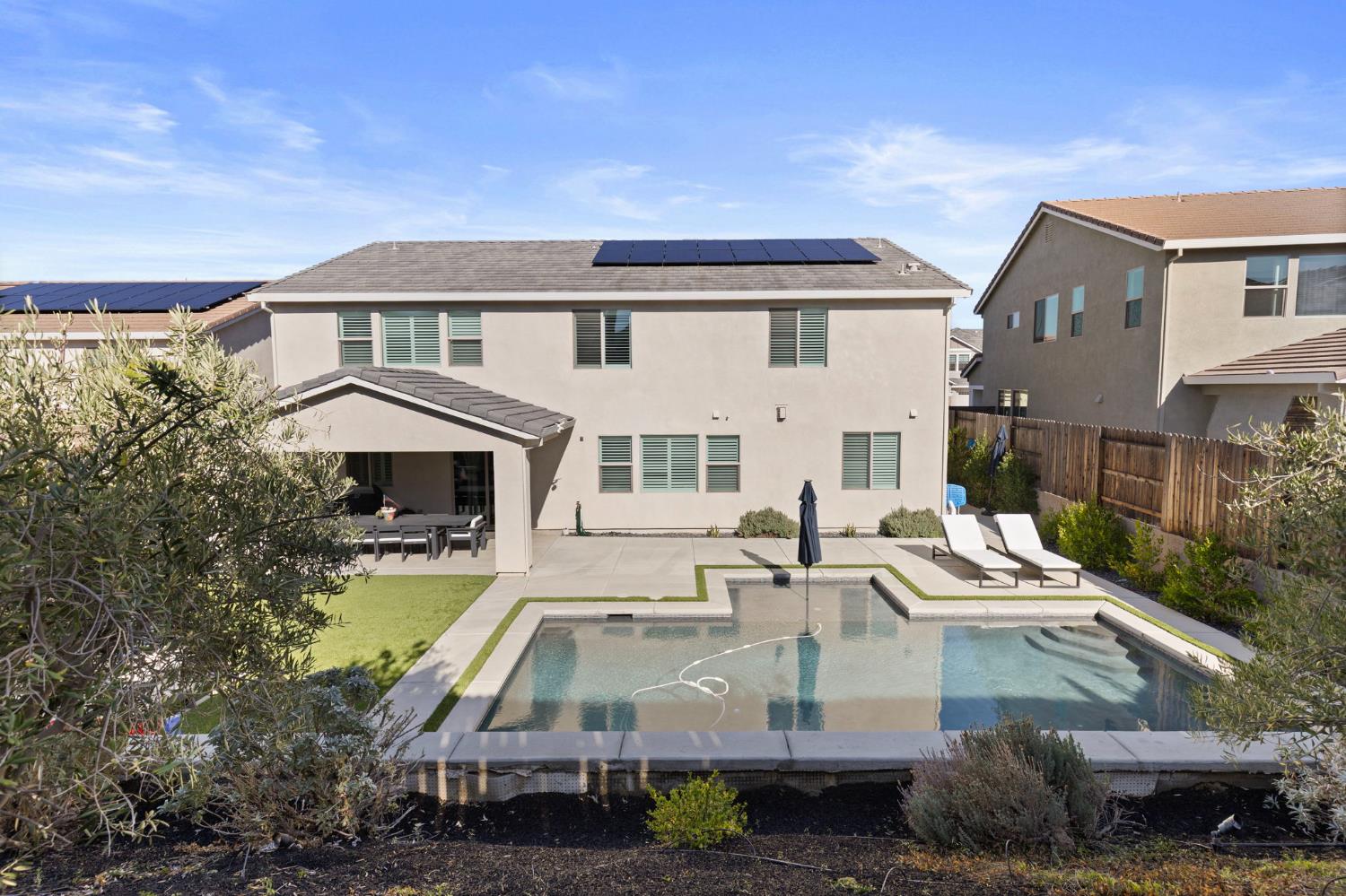 2948 Laredo Drive Rocklin, CA 95765 - Photo 52 of 54 a view of a white house with swimming pool and sitting area