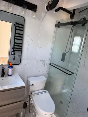 a bathroom with a toilet and a shower