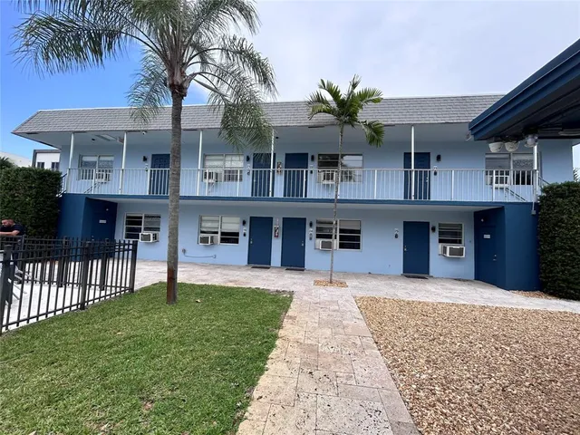 a front view of a house with a garden and yard
