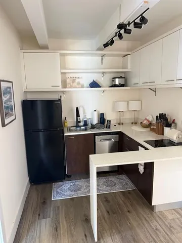 a kitchen with a refrigerator and a cabinets