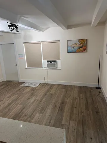 a view of a room with wooden floor