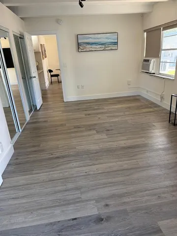 a view of a room with wooden floor and staircase