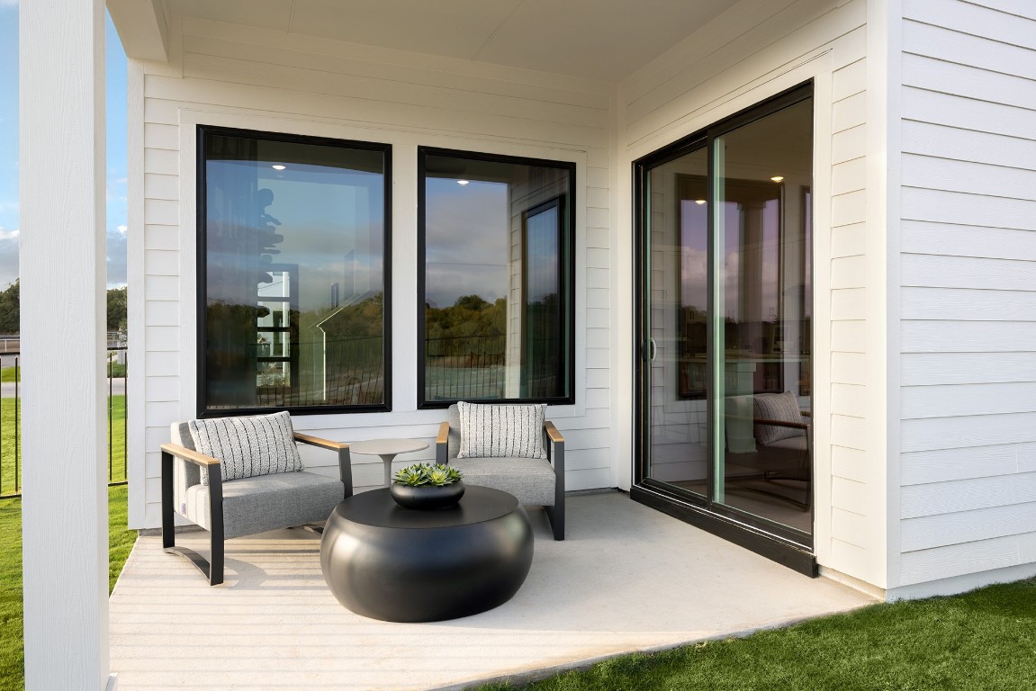 1407 Rambling Rose Road Austin, TX 78745 - Photo 12 of 12 a living room with furniture and large windows