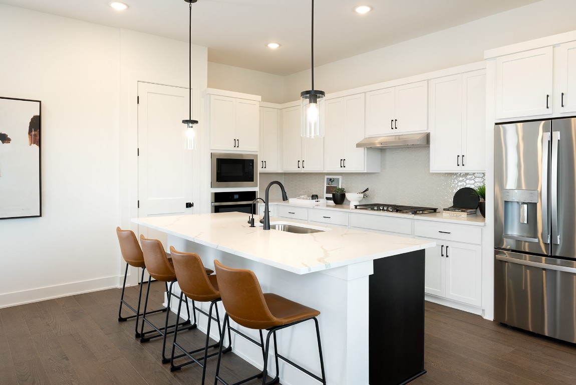1407 Rambling Rose Road Austin, TX 78745 - Photo 5 of 12 a kitchen with appliances a sink and cabinets