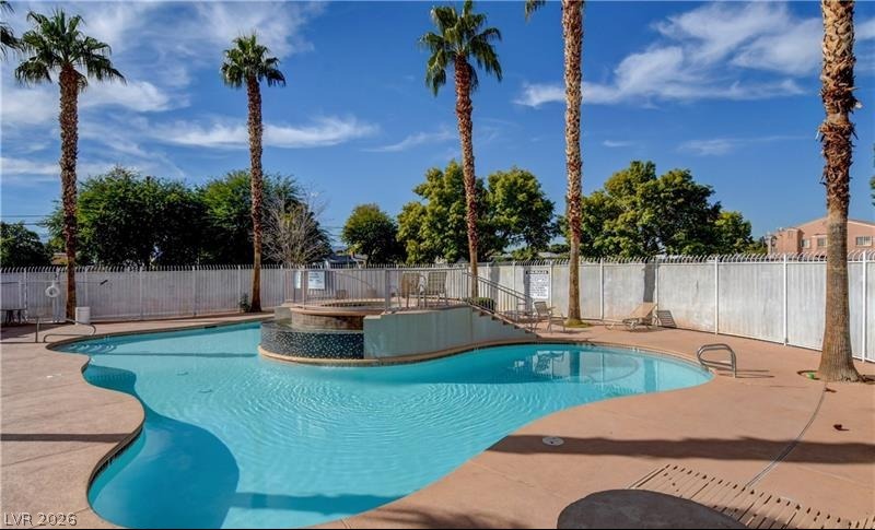 3318 North Decatur Boulevard, Unit 2093 Las Vegas, NV 89130 - Photo 9 of 10 An inviting community pool with a spa, ideal for relaxation and recreation.
