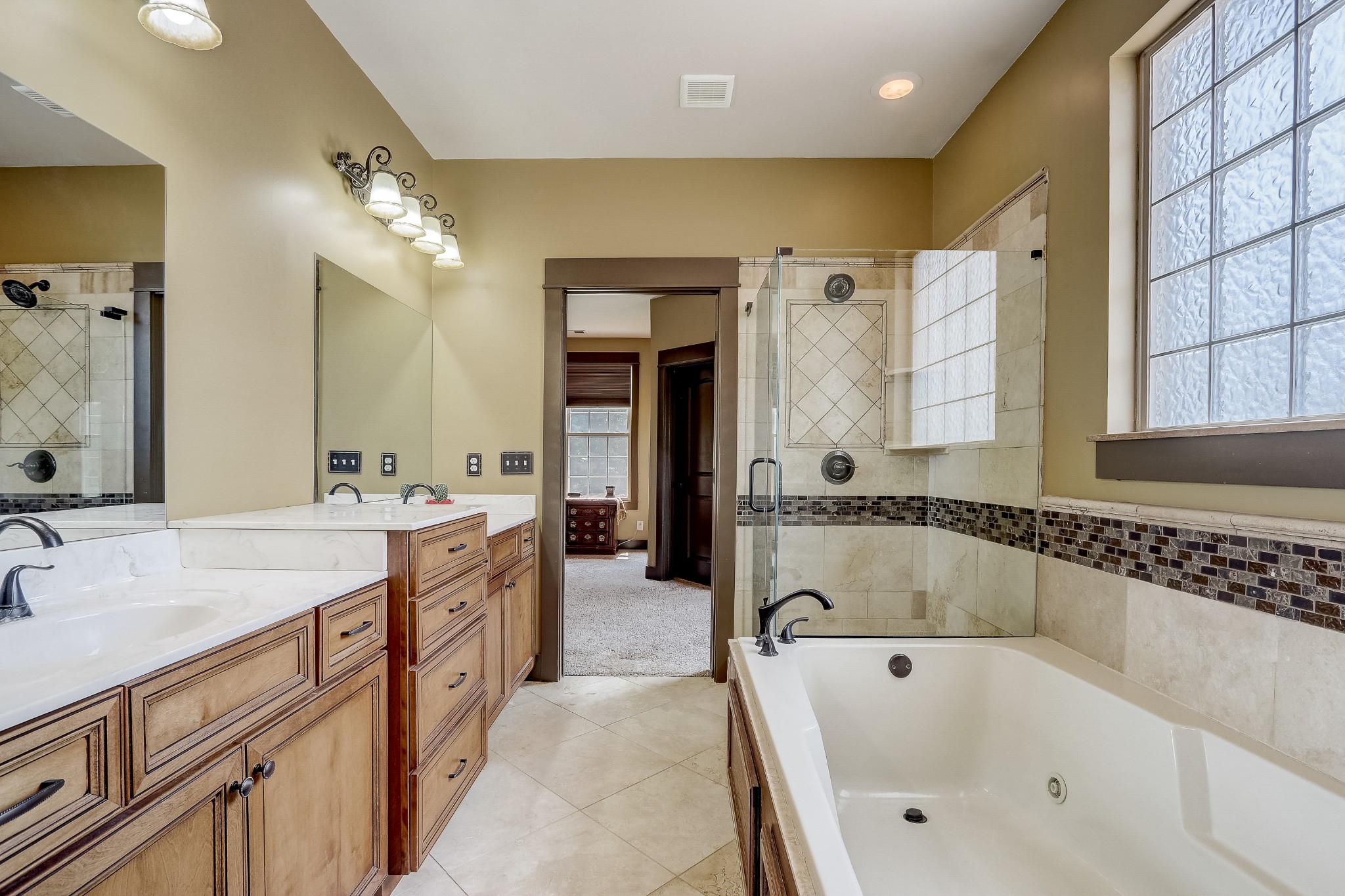 6745 Lovel Cook Road Springfield, TN 37172 - Photo 28 of 45 a bathroom with a tub a double vanity sink and mirror