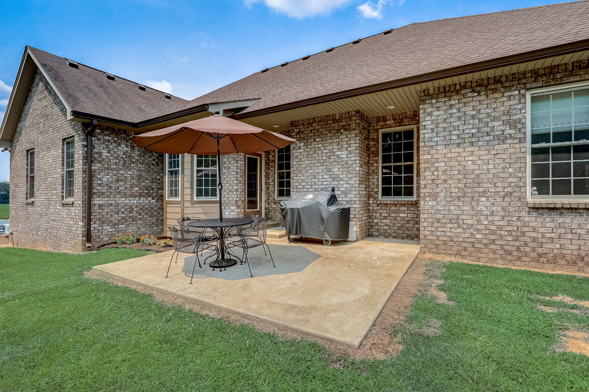 6745 Lovel Cook Road Springfield, TN 37172 - Photo 36 of 45 a view of a patio with table and chairs under an umbrella