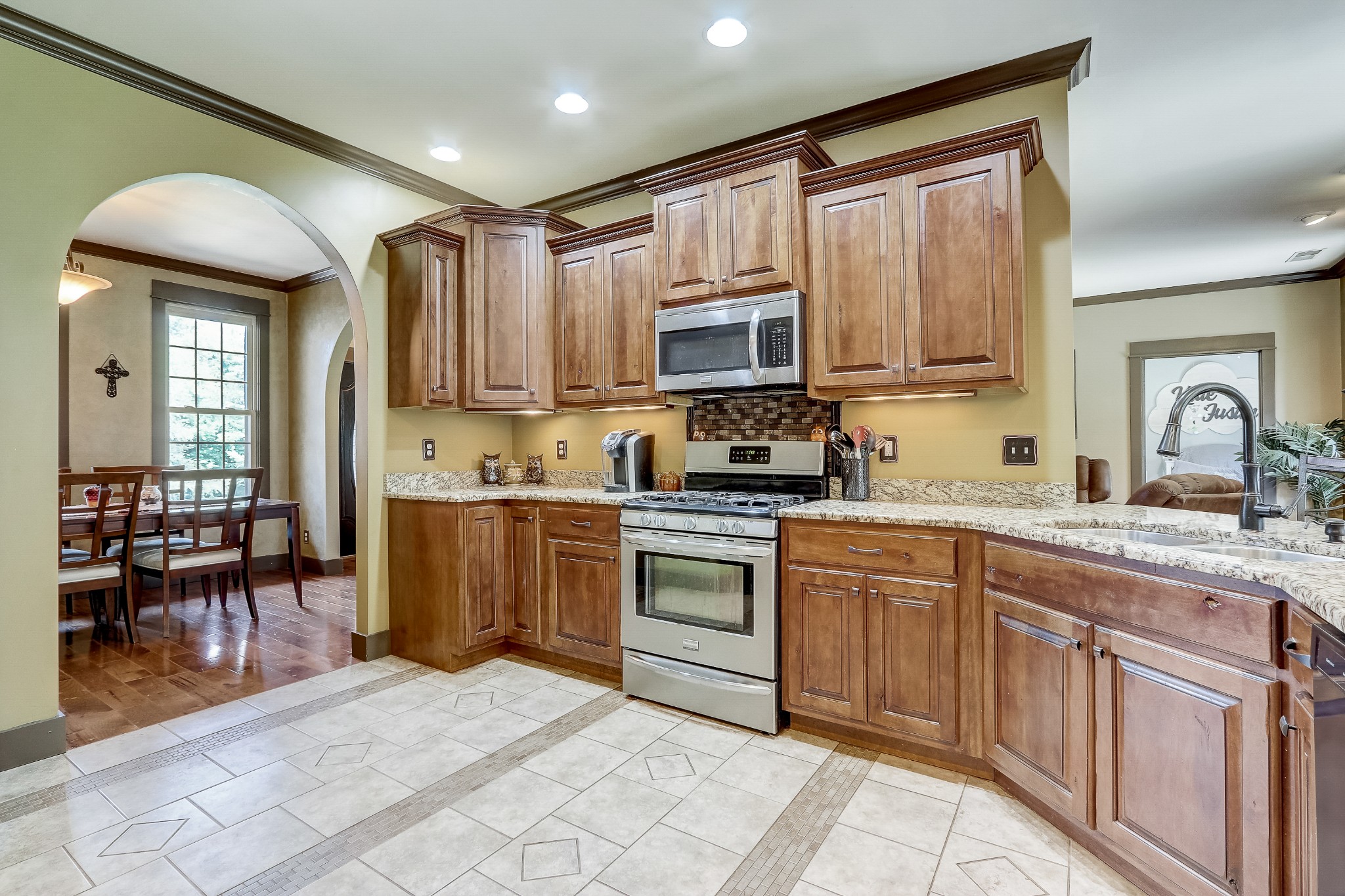 6745 Lovel Cook Road Springfield, TN 37172 - Photo 9 of 45 a kitchen with stainless steel appliances granite countertop a stove top oven a sink a dining table and chairs with wooden floor