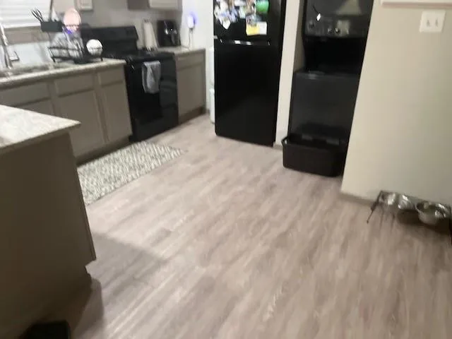 a kitchen with kitchen island sink and refrigerator