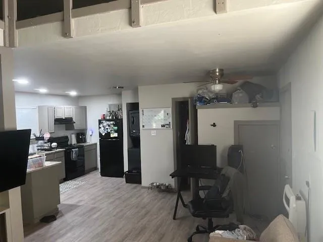 a kitchen with refrigerator and chairs