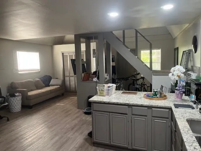 a bathroom with a granite countertop sink mirror and vanity