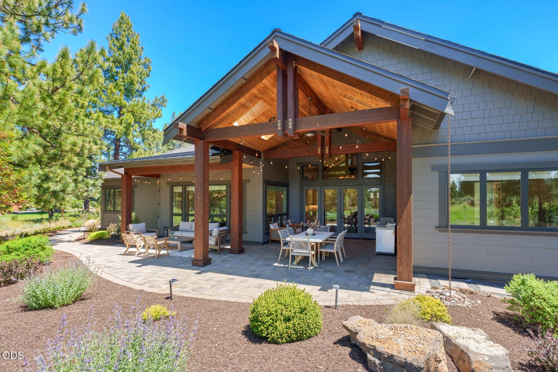 60255 Sunset View Drive Bend, OR 97702 - Photo 41 of 48 a patio with a table and chairs and potted plants