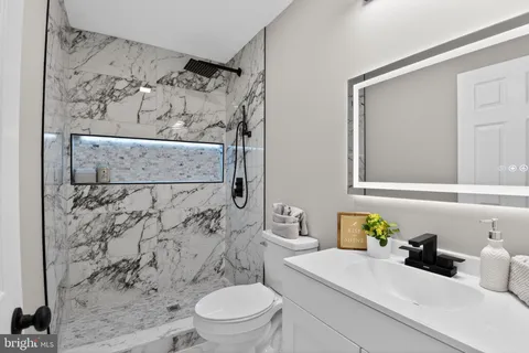 a bathroom with a sink toilet and shower