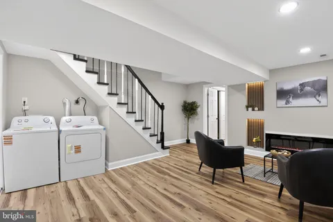 a view of a livingroom with furniture and staircase